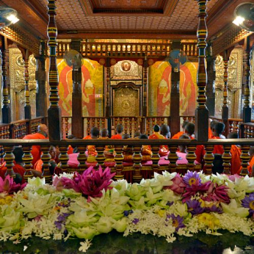 Kandy, Sri Lanka - April 6, 2018: Monks at the upper floor of Sri Dalada Maligawa, the Temple of the Sacred Tooth, during a ceremony.